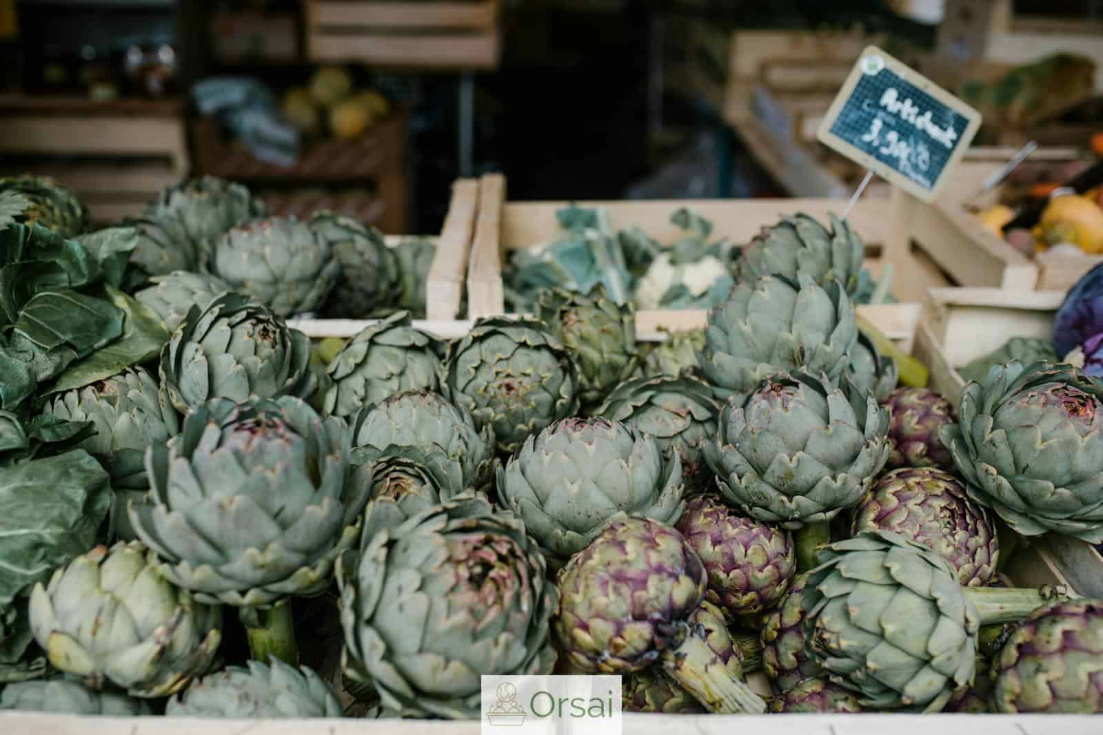 Ripe artichokes in boxes in market